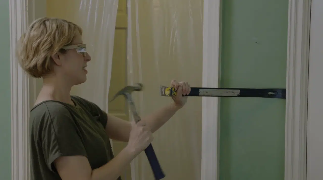 Using Estwing hammer and pry bar to demo an old house