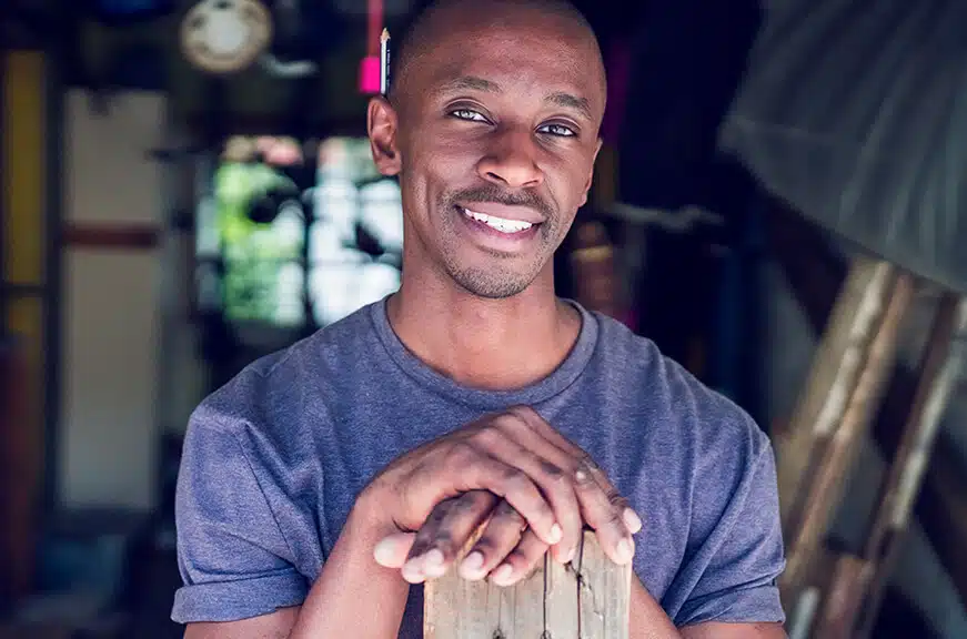 Man standing in garage smiling. Man standing in garage smiling.