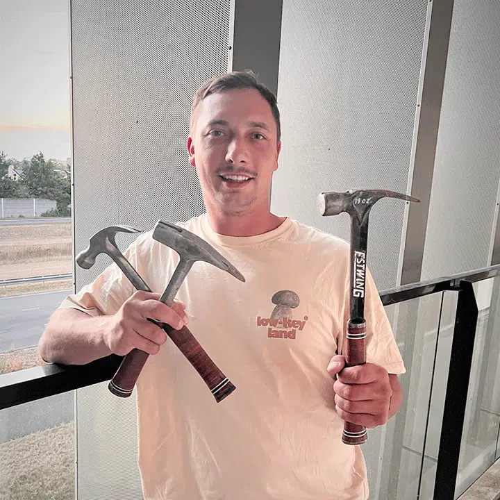 Man showing off collection of Estwing hammers