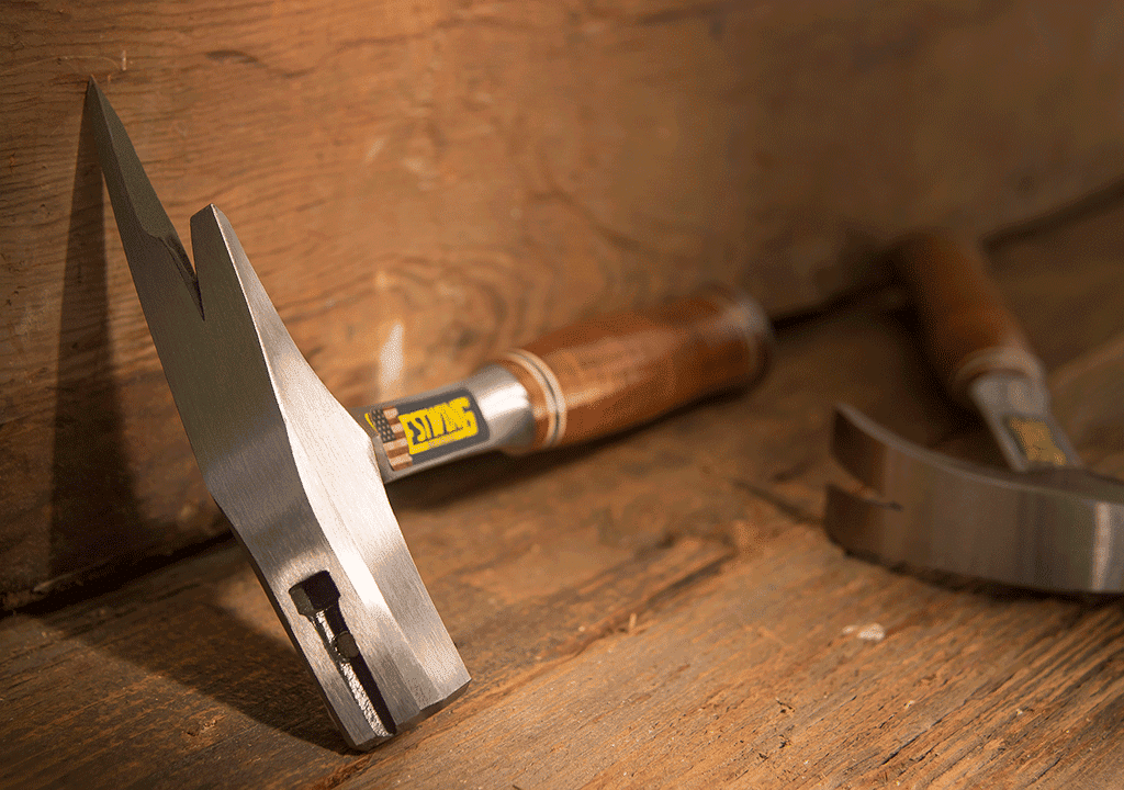 Estwing international hammers resting on old work surface