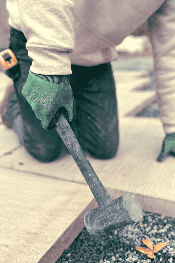 Tapping in patio paver with an Estwing deadblow hammer