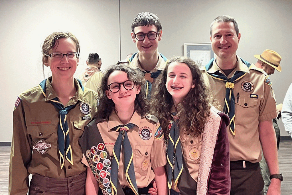 Family of scouts posing at an Eagle scout ceremony